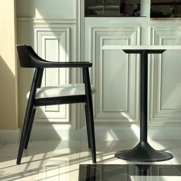 Side view of a set of black parawood side chairs with thick backrests