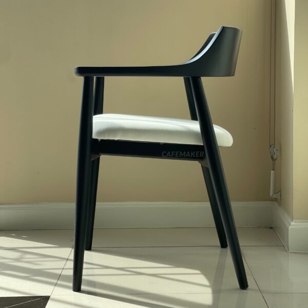 Side view of a black parawood side chair with a thick backrest showcasing its sturdy design