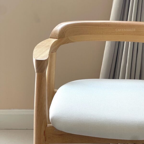 Close-up front view of a natural parawood side chair featuring a thin backrest, highlighting its design and craftsmanship