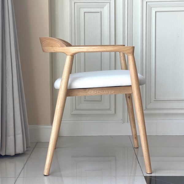 Side view of a natural parawood side chair with a thin backrest showcasing its sleek design