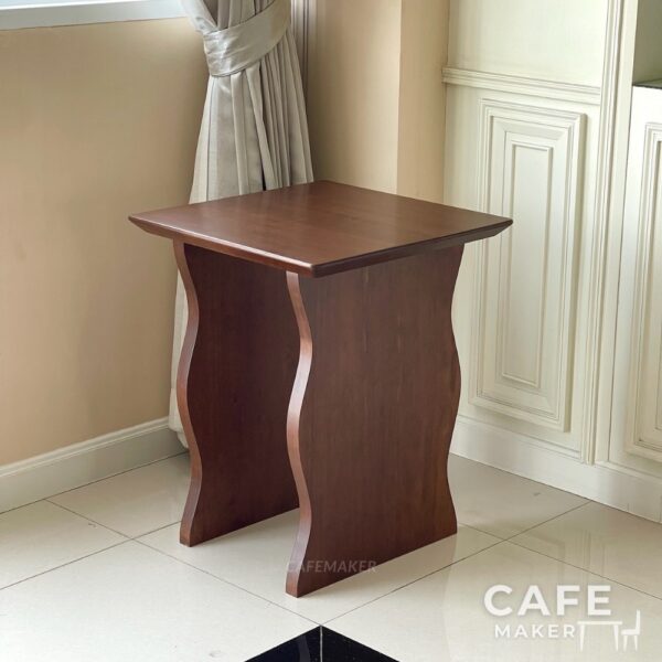 Isometric view of a walnut parawood cube table with wave-style legs