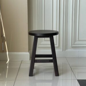 Front view of a walnut parawood round stool chair