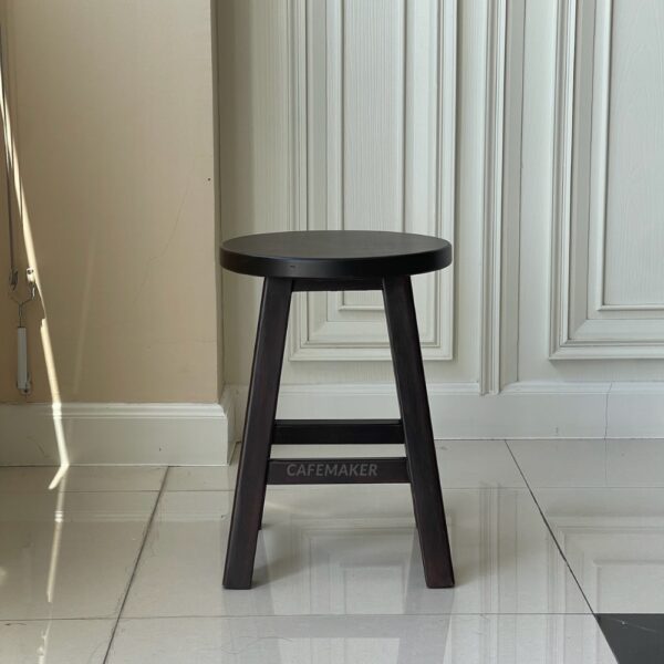 Front view of a walnut parawood round stool chair