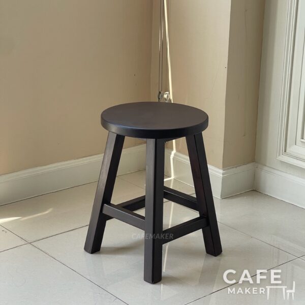 Isometric view of a walnut parawood round stool chair