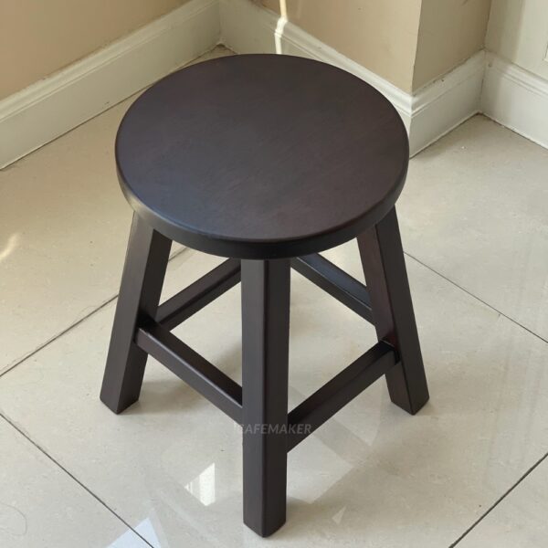Top view of a walnut parawood round stool chair showing its smooth surface