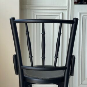 Back view of a wide black parawood Windsor chair, highlighting its classic backrest design
