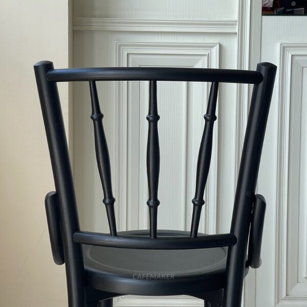 Back view of a wide black parawood Windsor chair, highlighting its classic backrest design