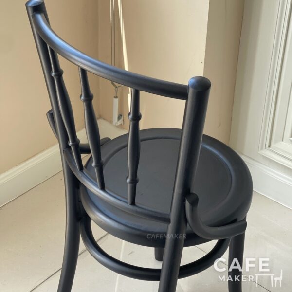Isometric back view of a wide black parawood Windsor chair, showcasing its classic backrest and sturdy design