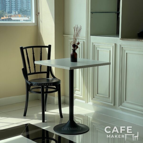 Set sample of wide black parawood Windsor chairs arranged together in a stylish display