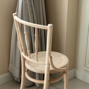 Isometric back view of a wide natural parawood Windsor chair, showcasing its classic backrest design and sturdy construction