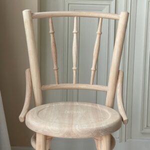 Front view of a wide natural parawood Windsor chair, highlighting its classic design and natural wood finish