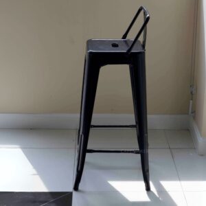 Side view of a black metal stool with backrest