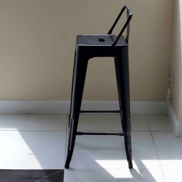 Side view of a black metal stool with backrest