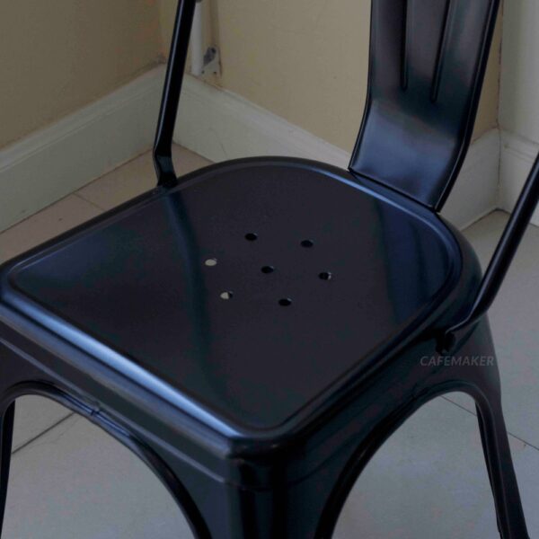 Close-up view of a black metal chair