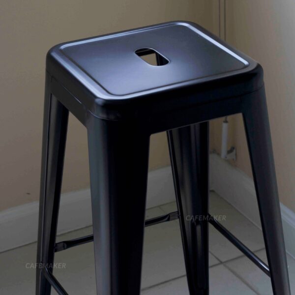 Close-up view of a black metal stool