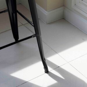 Close-up view of a black metal stool leg