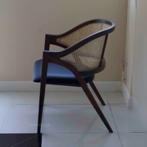 Side view of a black parawood rattan chair