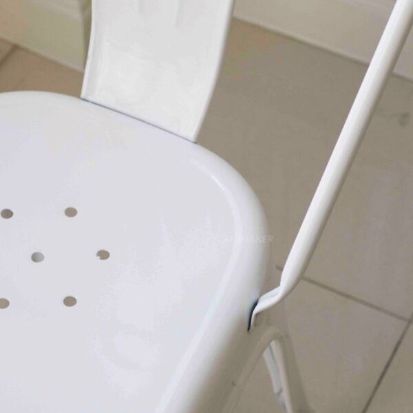 Close-up view of a white metal chair