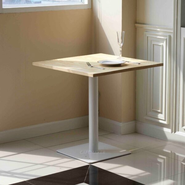Pine top table with white square leg used as a prop