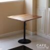 Isometric view of a walnut top table with champagne leg