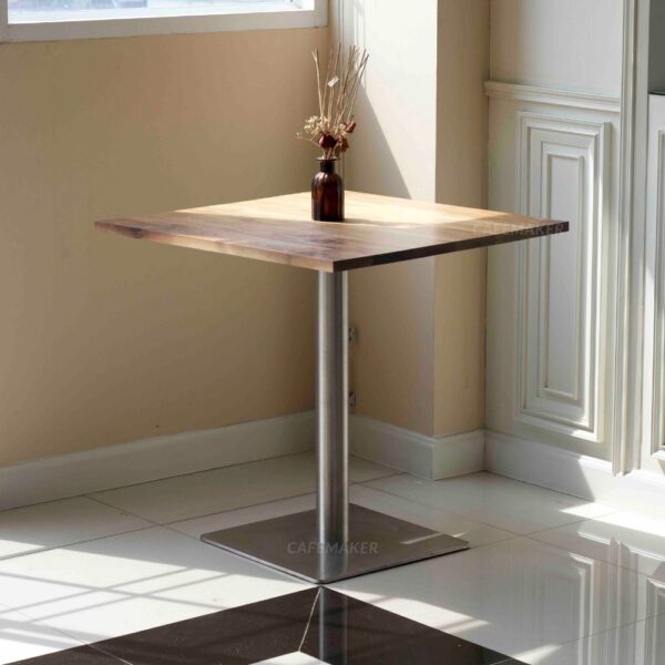 Walnut top table with square metal leg and a flower decoration