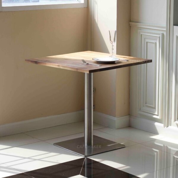 Walnut top table with square metal leg used as a prop