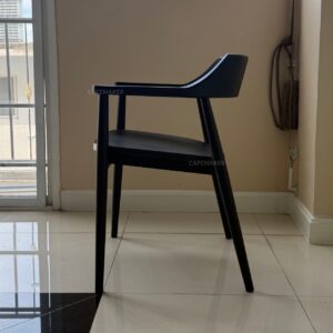 side view of black parawood chair with angled backrest and slim profile