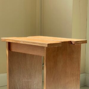 close-up top view of backless plywood chair with rectangular seat in natural finish