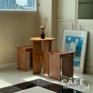 natural plywood dining set with round table and backless chairs styled with props