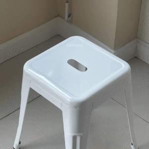 top view of white metal stool chair with circular seat and clean finish